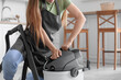 © Pixel-Shot - Young woman with vacuum cleaner in kitchen, closeup
