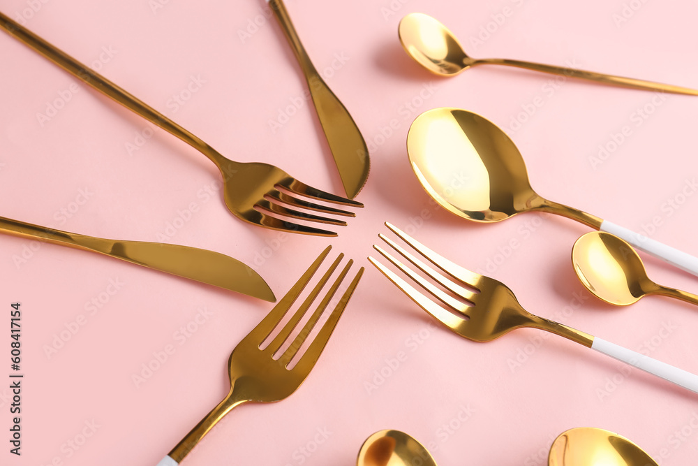 Stylish cutlery on pink background