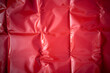 Photo of the texture of red latex fabric.Red latex background.Rubber fabric with pleats.