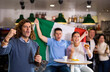 © JackF - Company of screaming young adult sports fans waving flag of Italy and supporting national team with beer in bar