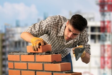 Poster - Young builder man during work at factory workplace.