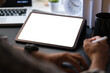 © wattana - Cropped shot businessman holding stylus pen and writing on display of digital tablet.