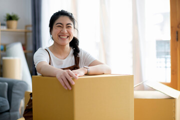 Wall Mural - Happy woman smiling at home during move with boxes