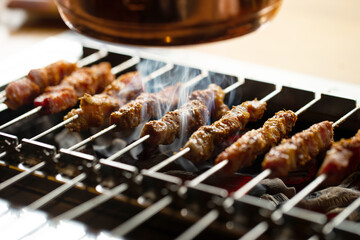 Canvas Print - Grilled lamb skewers over charcoal	