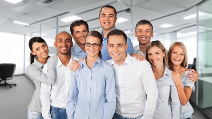 Wall Mural - Happy business team in office background