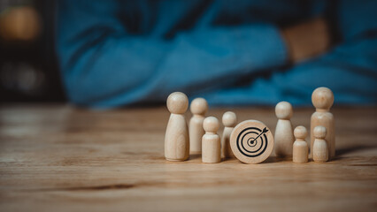 Business goals concept, young man thinking business goals, wooden dummy representing a group of people who need work goals to achieve, business goals, human resource management