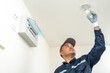© Chanakon - Electrician installing led light bulbs at home for power saving. Fixing changing the Light Inside apartment. Home service concept.