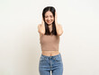 © Chanakon - Young asian woman put hands on her ears. Annoyed noise of loud music. Asian female lady standing pose covering ears with hands on isolated white background.