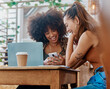 © Oostendorp/peopleimages.com - Phone, cafe and happy women or friends with social media, restaurant and online meme for e learning or university remote work. African people or students at coffee shop on mobile app, web and college