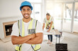 © Clayton Daniels/peopleimages.com - Portrait of man, construction and home renovation with arms crossed, helmet and smile in apartment. Yes, positive mindset and renovations, happy handyman in safety and building project in new house.