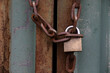 old rusty  chain and padlock on metal door
