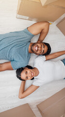 Wall Mural - Top view, home and couple with boxes, real estate and excited on the floor, living room and mortgage. Portrait, man and woman on the ground, cardboard and relationship with property and apartment