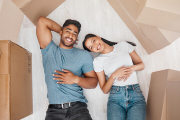 Canvas Print - Top view, home and couple with boxes, ground and relationship with property, living room and apartment. Portrait, happy man or woman on the floor, cardboard and property with investment and new house