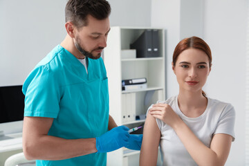 Poster - Doctor giving hepatitis vaccine to patient in clinic