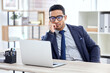 Businessman in glasses, thinking or reading on laptop in office, desk or corporate workplace with professional employee. Man, business and focus on working, planning or entrepreneur busy on computer
