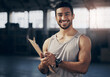 © Shadroy J/peopleimages.com - Fitness, clipboard and portrait of a personal trainer in the gym working on a training schedule. Confidence, happy and male athlete writing a workout or exercise plan for wellness in a sports center.