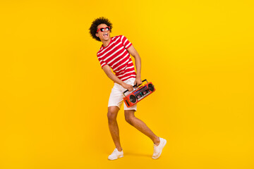 Sticker - Full size photo funky guy dance youth party carry boom box wear shirt pants shoes sun specs isolated yellow color background