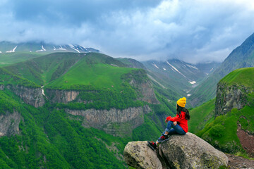 Wall Mural - Tourist sitting and enjoy view near russian georgian friendship monument, Georgia.