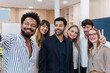 © Westend61 - Happy business team posing for a selfie in office