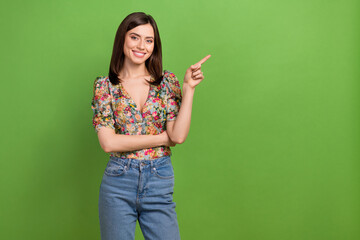 Wall Mural - Photo portrait of attractive girl promoter worker direct finger empty space wear floral shirt jeans isolated green color background