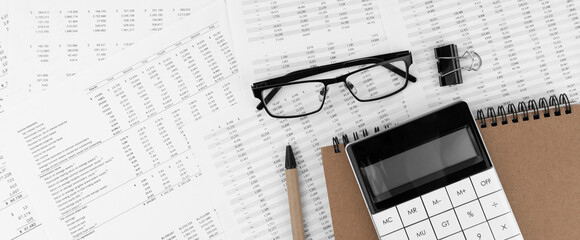 Poster - Calculator, pen,notebook and eye glasses lying on financial statement.