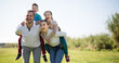 © caftor - happy family of parents with two children enjoy a walk in city park