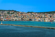1813 stone-built water-surrounded obelisk next to De Bosset Bridge with Argostoli town panorama in the background on the Ionian Island of Cephalonia Greece.