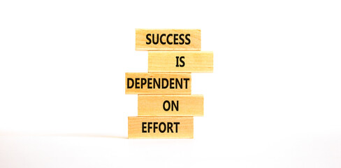 Wall Mural - Success and effort symbol. Concept words Success is dependent on effort on wooden block. Beautiful white table white background. Business success and effort concept. Copy space.
