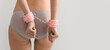 © Pixel-Shot - Young woman in panties and handcuffs from sex shop on grey background, back view. Banner for design