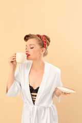 Poster - Young pin-up woman with cup of coffee on beige background