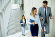 © BGStock72 - Young startup team have a discussion while climbing on  stairs in the office corridor