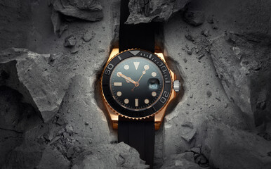 Wall Mural - A beautiful luxury men's gold watch built into or embedded in a rock or stone. Stylish golden watch on a beautiful background of stones or rocks. Advertising photo of the watch
