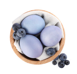 Wall Mural - Colorful Easter eggs painted with natural dye and fresh blueberries on white background, top view