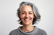 © Anne-Marie Albrecht - Portrait of smiling middle-aged woman with gray hair on white background