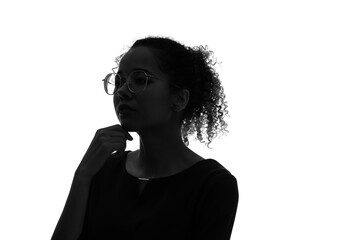 Profile silhouette of thinking black woman in studio shot.