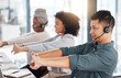 © C.D./peopleimages.com - Call center, headset and team stretching at desk while tired or to start telemarketing work. Diversity women and a man together at a desk to exercise for crm, customer service and help desk support