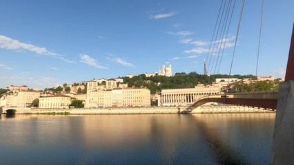 Wall Mural - Morning clip of St Jean and Fourviere hill, near footbridge over Saone river to historic courthouse (