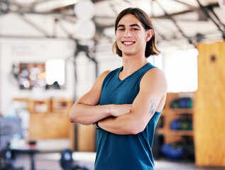 Canvas Print - Coach, portrait and man with arms crossed in gym ready to start training, workout or exercise for health and wellness. Fitness, face and smile of confident athlete or personal trainer from Canada.