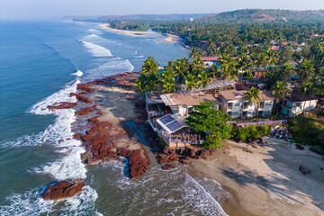 Wall Mural - Aerial top view on tropical beach with green palm trees under sunlight Drone view in Goa