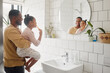 © K.A./peopleimages.com - Brushing teeth, father and child in home bathroom for dental health and cleaning in mirror. African man, girl kid or learning to clean mouth with toothbrush for morning fun, oral hygiene or self care