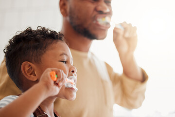 Brushing teeth, child and dad in a home bathroom for dental health and wellness. Face of a man and african kid learning to clean mouth with a toothbrush and toothpaste for oral hygiene and self care