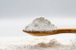 Powdered sugar on wooden spoon. Powdered sugar or icing sugar isolated on white background