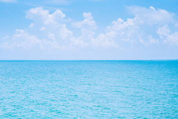Wall Mural - sea or ocean calm water with blue sky and white clouds.