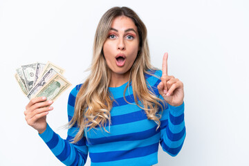 Canvas Print - Young Uruguayan woman taking a lot of money isolated on white background intending to realizes the solution while lifting a finger up