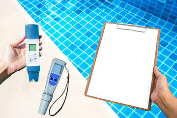 Wall Mural - Digital water tester with blank paper clipboard over clear swimming pool water, best water quality, pool maintenance and service, good quality Water tester for swimming pool