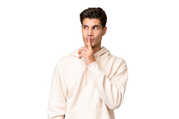 Young caucasian handsome man over isolated background showing a sign of silence gesture putting finger in mouth