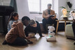 © Maskot - Multiracial students sitting in front of modern robot in innovation lab