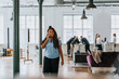 © Maskot - Thoughtful businesswoman talking on smart phone while walking in office