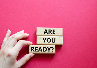 Are you ready symbol. Concept word Are you ready on wooden blocks. Businessman hand. Beautiful red background. Business and Are you ready concept. Copy space