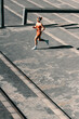 © Jacob Lund - Wellbeing and exercise: Athletic woman running up stairs for cardio training